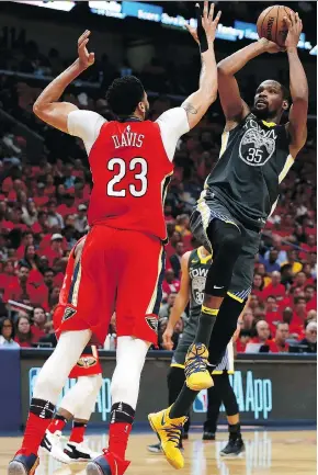  ?? SEAN GARDNER/GETTY IMAGES ?? Kevin Durant shoots over Anthony Davis during action Sunday in New Orleans. He finished with 38 points on 15-of-27 shooting to go with nine rebounds.