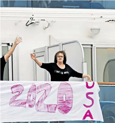  ??  ?? A Valentine’s Day message for the US president from Americans on the Diamond Princess in Japan, who are being brought home. Below, a passenger on the MS Westerdam in Cambodia has a final health check before leaving