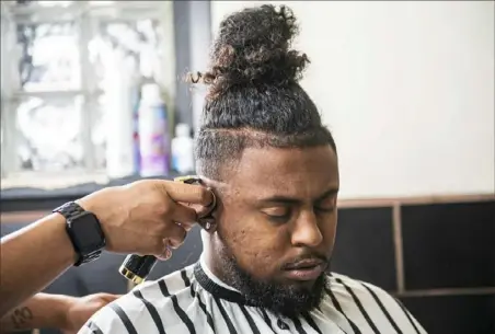  ?? Post-Gazette ?? Brothers of Steelers also figure in the mix. Antoine Dion Thomas works on Xavier Banner, brother of Steelers lineman Zach Banner. Thomas has been cutting the hair for Steelers players since meeting Le’Veon Bell in 2013.