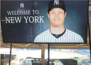  ?? AP ?? A video screen displays a recent photo of Gerrit Cole before he is introduced as the newest Yankee.