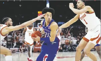  ?? AP PHOTO/ERIC GAY ?? Kansas forward Jalen Wilson (10) drives between Texas forward Timmy Allen (left) and forward Dylan Disu (1) during the first half of an NCAA college basketball game in Austin, Texas, on Saturday.