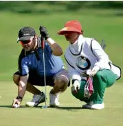  ??  ?? ACC Marketing Director Karl Magsuci lines up the ball with his caddy.