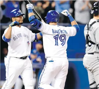  ?? FRANK GUNN/ THE CANADIAN PRESS ?? Toronto Blue Jays’ Jose Bautista celebrates with teammate Edwin Encarnacio­n after hitting a solo home run in the team’s 5-3 win over the Tampa Bay Rays Friday.