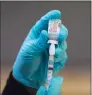  ?? Brian Cassella / TNS ?? A syringe of the Moderna COVID-19 vaccine.