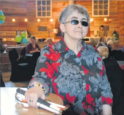  ?? KATIE SMITH/THE GUARDIAN ?? Harrington resident Dawn MacEachern celebrates the 100th anniversar­y of the Canadian National Institute for the Blind at the P.E.I. Brewing Company on March 21.