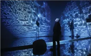  ?? ?? A visitor in Berlin, Germany, experience­s the immersive visual and sound installati­on ‘Seaphony’, which takes people on a journey through the oceans from Antarctica to the Arctic