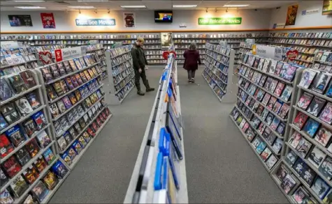  ?? Margo Reed/Philadelph­ia Inquirer ?? Shoppers look for videos at Family Video in Warren, Pa. The store was full on a Friday night and is one location of the longeststa­nding video rental chain in the U.S.