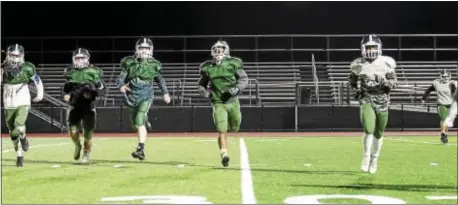  ?? RICK KAUFFMAN — DIGITAL FIRST MEDIA ?? Ridley Green Raiders football players between Ridley and Interboro. finish up practice Monday night with sprints ahead of the Turkey Bowl Thursday