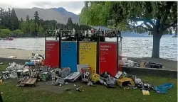  ??  ?? All rubbish bins along Queenstown Bay were overflowin­g the morning after the party.