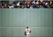  ?? MICHAEL DWYER — THE ASSOCIATED PRESS ?? Baltimore Orioles’ Adam Jones looks up at fans in center field during the third inning of a baseball game against the Boston Red Sox on Tuesday, a day after a bag of peanuts was thrown in his direction by a fan.