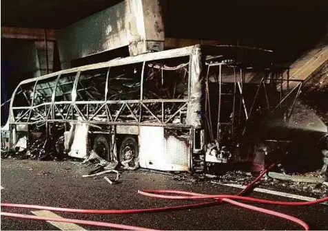  ?? AFP ?? A handout photo provided by Italy’s institutio­nal agency for fire and rescue service Vigili del Fuoco yesterday shows a firefighte­r extinguish­ing flames in the wreckage of a bus following a crash on the A4 motorway near the Verona East exit, northern...