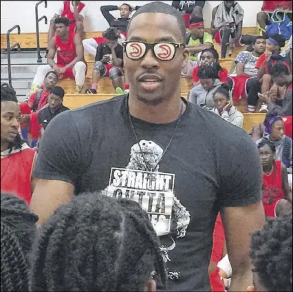  ?? STEVE HUMMER / SHUMMER@AJC.COM ?? Dwight Howard, a former Southwest Atlanta Christian Academy standout, clowns around with kids at the 12th annual Howard & Howard Basketball Camp on Friday.