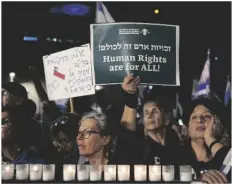  ?? AP PHOTO/TSAFRIR ABAYOV ?? Israelis protest against the plans by Prime Minister Benjamin Netanyahu’s new government to overhaul the judicial system, in Tel Aviv, Israel, on Saturday.