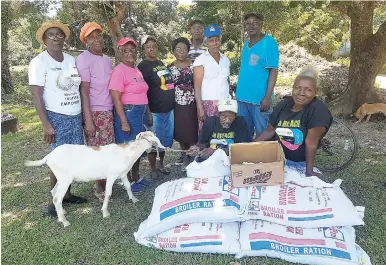  ??  ?? Some members of the Golden Valley Jamaica Agricultur­al Society group with start-up items for their livestock project.