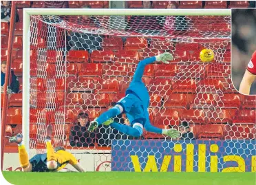  ??  ?? Stenhousem­uir’s Mark Mcguigan sends a diving header past Aberdeen keeper Joe Lewis