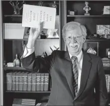  ?? VIA USA TODAY] ?? Ambassador John Bolton holds up his new book as he mimics photos of President Trump holding a bible in Layfayette Square. [JASPER COLT