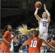  ?? JESSICA HILL — THE ASSOCIATED PRESS ?? Connecticu­t’s Katie Lou Samuelson, shoots over Syracuse’s Gabby Cooper, left, and Isabella Slim.
