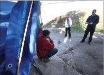  ?? PHOTO BY STAN LIM ?? Volunteers Brittany Cardoza and Jacob Nuchols, both deputies with the Riverside County Probation Department, interview a homeless man living in a creek bed near Limonite Avenue and Clay Street in Jurupa Valley in 2018.