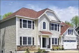  ??  ?? Above, homes built by Griner Brothers Builders include, left, 84 Fiddlers Lane, Loudonvill­e, and, right, 667 Boght Road, Cohoes. At top, kitchen at 84 Fiddlers Lane.