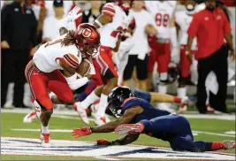  ?? ASSOCIATED PRESS ?? Running back Bell producing so far UTAH’S BOOBIE HOBBS (1) avoids the tackle from Arizona’s Demetrius Flannigan-Fowles on a punt return during the first half of an NCAA college football game Friday in Tucson, Ariz.