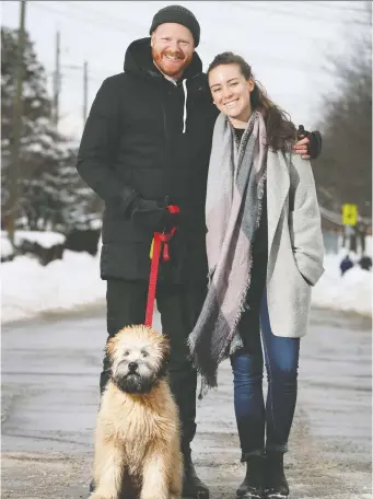  ?? TONY CALDWELL ?? Shawn Tavenier poses for a photo with his partner Emily Scantlebur­y and his dog King Arthur. Tavenier was a successful gigging musician before the pandemic.