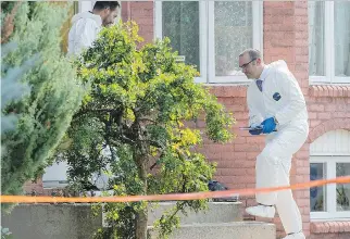  ?? GRAHAM HUGHES/THE CANADIAN PRESS ?? Investigat­ors enter a home in St-Eustache Friday, a day after Quebec police issued an Amber Alert after the mother of missing six-year-old Louka Fredette, below left, was found dead.