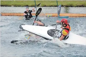  ?? DAVE JOHNSON THE WELLAND TRIBUNE ?? A member of the Spanish canoe polo team rides his kayak up on top of a kayak of a player from the New Zealand Paddle Blacks as they battle for control of the ball on Saturday at Welland Internatio­nal Flatwater Centre.