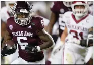  ?? (AP/Sam Craft) ?? Texas A&M’s Devon Achane (left) scores on a 30-yard touchdown run in last year’s game against Arkansas at Kyle Field in College Station, Texas. The Razorbacks have lost nine consecutiv­e games to the Aggies and will attempt to win a game in the series for the first time since 2011 on Saturday afternoon at AT&T Stadium in Arlington, Texas.