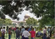  ?? - PTI ?? ANXIOUS: Media personnel outside the Supreme Court before the verdict on triple talaq in New Delhi on Tuesday.