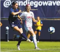  ?? K.C. ALFRED U-T ?? Kaleigh Riehl of the San Diego Wave FC (left) scores as Amanda Kowalski of the Chicago Red Stars arrives too late to stop her.