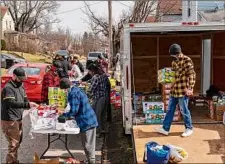  ?? Michael Swensen / Getty Images ?? A local chapter of the Proud Boys hand out water, food and cleaning supplies to residents in East Palestine, Ohio.