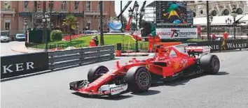  ?? AFP ?? Ferrari’s Sebastian Vettel in action during the practice session at the Monaco street circuit yesterday, three days ahead of the Monaco Formula 1 Grand Prix.