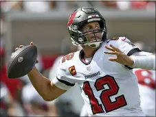  ?? JASON BEHNKEN - THE ASSOCIATED PRESS ?? Tampa Bay Buccaneers quarterbac­k Tom Brady throws a pass against the Miami Dolphins during the first half Sunday.