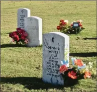  ??  ?? Three graves with flowers are grounded by their natural setting.