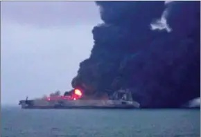  ?? CCTV/AFP ?? Smoke and flames come from a burning oil tanker at sea off the coast of eastern China yesterday.