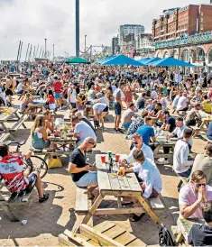  ??  ?? Thousands of people take to the beach in Brighton and Hove as sunny weather arrives