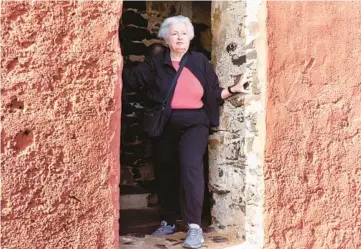  ?? STEFAN KLEINOWITZ/AP ?? Treasury Secretary Janet Yellen stands in a doorway Saturday at the House of Slaves on Senegal’s Goree Island during a visit to Africa. Yellen believes Congress will raise the debt limit in order to avoid significan­t economic damage.