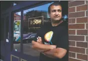  ?? (AP/Charles Rex Arbogast) ?? Mallick stands outside his restaurant in Chicago. When Mallick opened last year, he was focused on building his business and getting rave reviews about the eatery’s “progressiv­e Indian cuisine” from the city’s top critics. Now some of his biggest fans are on the city’s South Side, where he regularly delivers hundreds of meals to those hardest-hit by the pandemic.