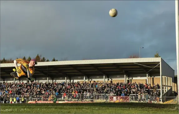  ??  ?? Dr. Crokes goalkeeper Shane Murphy makes a flying save from Luke Connolly, Nemo Rangers, during Sunday’s Munster Club SFC Final at Páirc Ui Rinn. Photo by Sportsfile