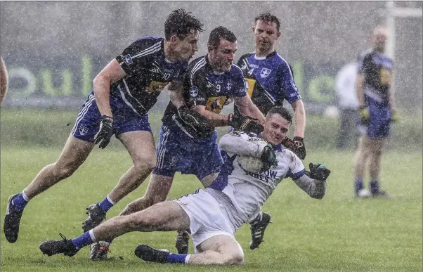  ??  ?? St Pat’s Eamonn Wolfe is challenged by Blessingto­n’s Bryan Carroll during the SFC quarter-final in Joule Park, Aughrim. Picture: Garry O’Neill