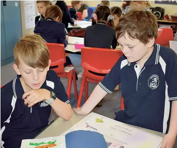  ??  ?? Darnum Primary students Liam (left) and Ollie enjoy participat­ing in the recent Writers’ Cafe at school.