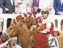  ?? ROBERSON/AP JEFF ?? Jockey Sonny Leon rides Rich Strike in the winner’s circle after a victory in the 148th running of the Kentucky Derby at Churchill Downs on Saturday in Louisville, Ky. Rich Strike was an 80-1 long shot to win.