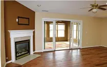  ?? KATHY TYLER / CONTRIBUTE­D ?? Tucked into one corner of the great room is a gas fireplace with a wood mantel and ceramic tile hearth.