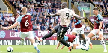  ?? — AFP photo ?? Manchester United’s Belgian striker Romelu Lukaku (second left) scores his team’s second goal during the English Premier League football match between Burnley and Manchester United at Turf Moor in Burnley, north west England.