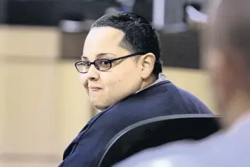  ?? LANNIS WATERS/ THE PALM BEACH POST ?? Berenice Juarez turns to smile at family members on Thursday. She was sentenced to 51 years in prison for killing her mother’s boyfriend in 2010. Juarez will be eligible to ask a court to review her case after serving 25 years in prison.