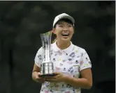  ?? TIM IRELAND — THE ASSOCIATED PRESS ?? Japan’s Hinako Shibuno reacts as she holds the trophy as she celebrates after winning the Women’s British Open golf championsh­ip at Woburn Gold Club near near Milton Keynes, England, Sunday.