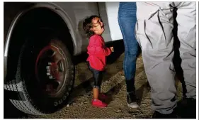  ?? JOHN MOORE / GETTY IMAGES ?? A 2-year-old Honduran girl cries June 12 as her mother is searched and detained in McAllen after the two rafted across the Rio Grande to seek asylum. About 2,000 children have been separated from their parents since April.