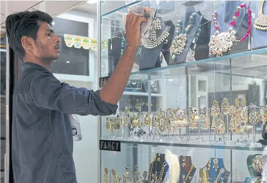  ??  ?? TAKING A SHINE: A jewellery shop in New Delhi’s gold and diamond district, where cash has ruled since the jewellery market opened in the 17th century.