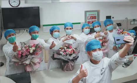  ?? ZHAO JUN / FOR CHINA DAILY ?? Mothers and daughters as well as one mother and her son, who all worked as nurses treating COVID-19 patients at Wuhan University Zhongnan Hospital, celebrate Internatio­nal Nurses Day in advance on Friday.