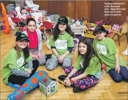  ??  ?? Young volunteers with donated toys. Opposite: Iain Duncan Smith chats to guests